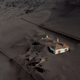 This aerial picture shows a house covered with lava and ashes following the eruption of the Cumbre Vieja volcano in Las Manchas on the Canary Island of La Palma on Dec. 14, 2021.